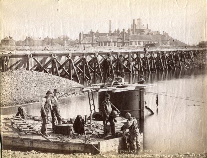 Diver H.W. Phillips at Shirley Gut with the Deer Island Alms House in background, Oct. 1893.